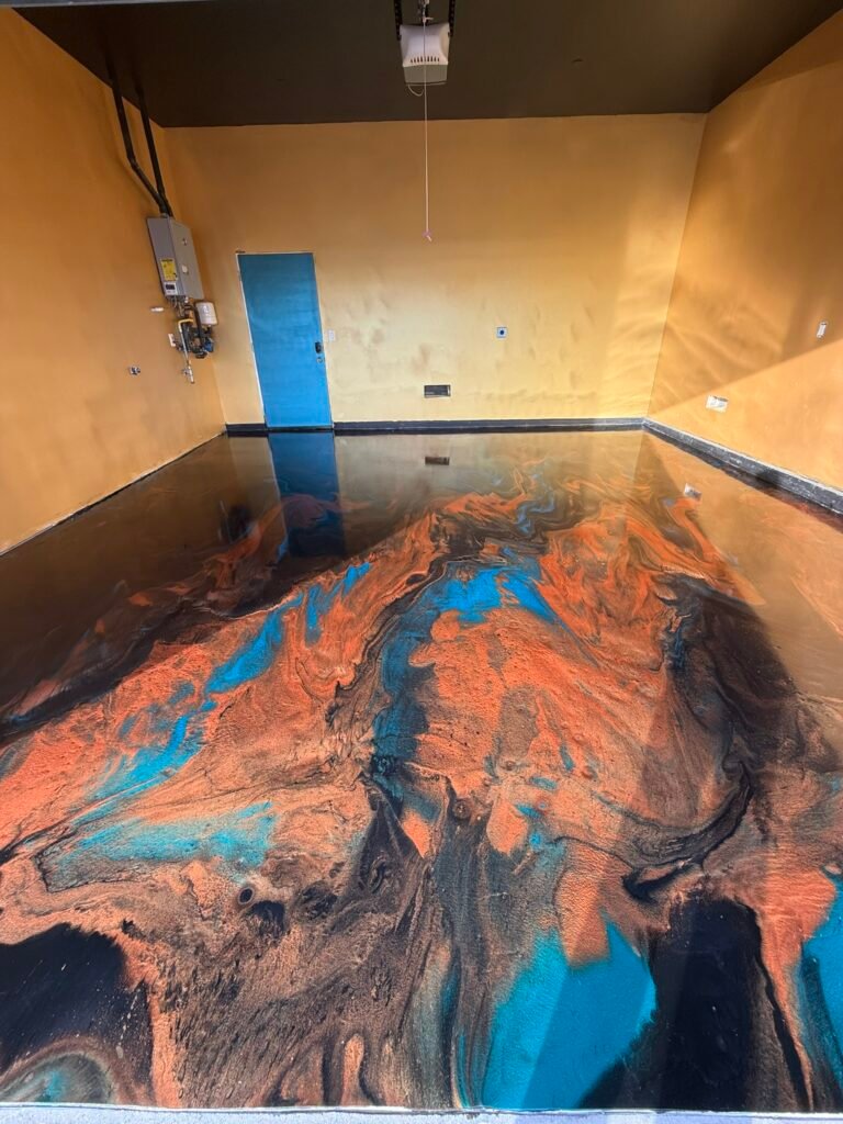 Custom orange and turquoise metallic epoxy garage floor installed by Zenith Heights