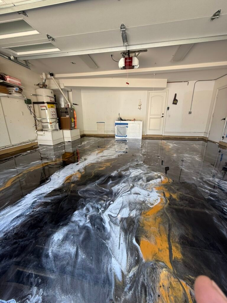 Black, white and gold metallic epoxy garage floor installed in San Diego