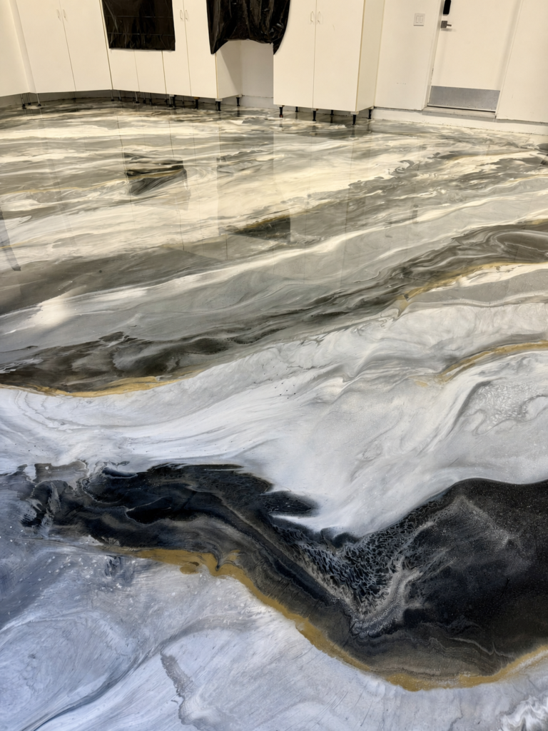 Custom black, white and gold metallic epoxy floor installed by Zenith Heights in San Diego